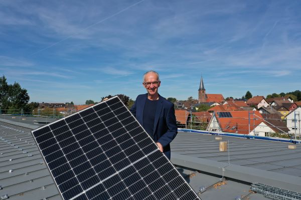 Bürgermeister Wein mit Photovoltaikanlage auf dem Dach der Sporthalle Bischweier